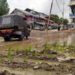 As a mark of protest, locals plant paddy saplings in potholes in Kupwara